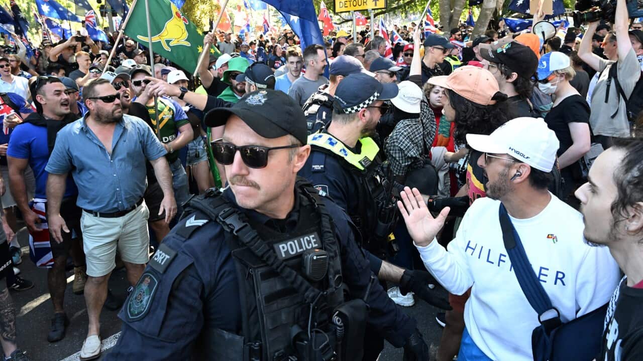 Police are seen separating Anti-immigration protesters and Pro-immigration protesters in Brisbane (AAP)