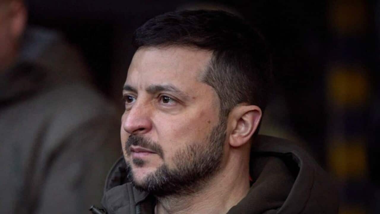 A man wearing winter clothing looking on.