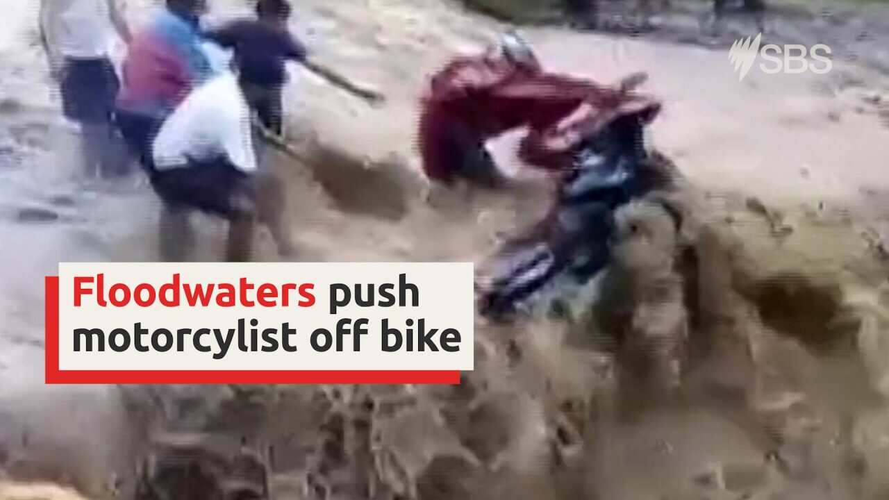 Floodwaters push motorcyclist off the road in Nepal