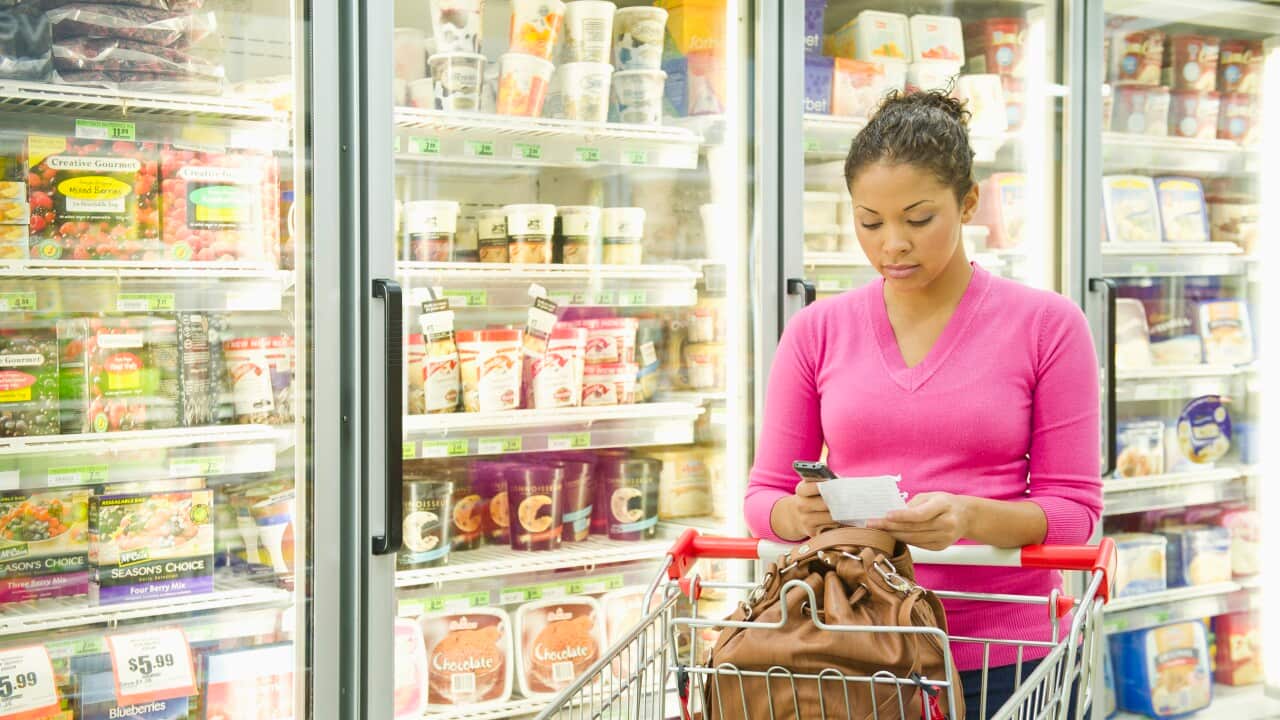 A woman shopping in frozen food aisle