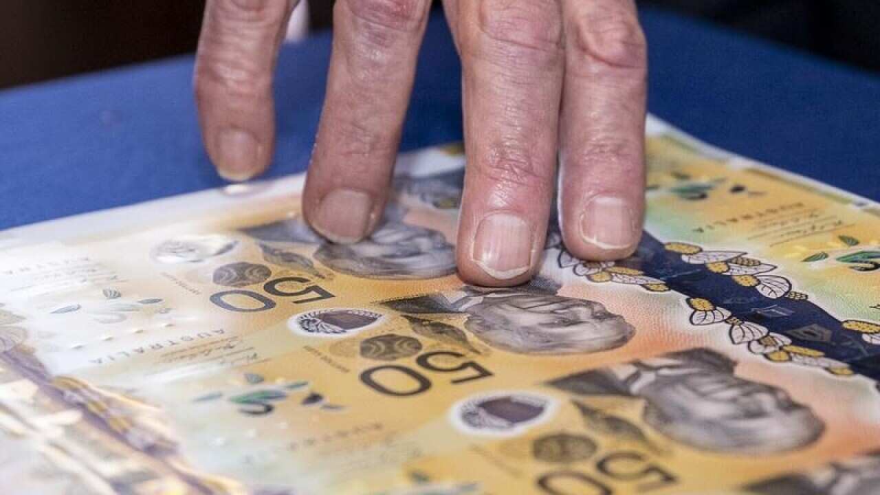 Inspecting a banknote.