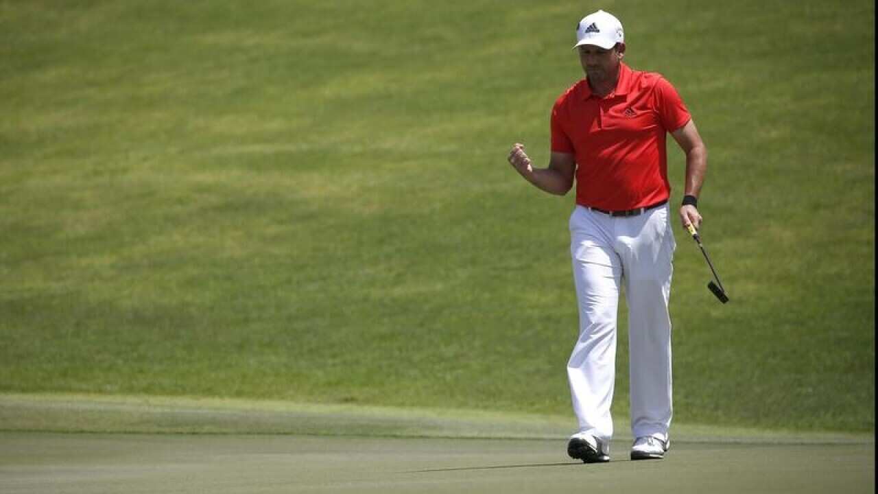 Sergio Garcia of Spain reacts after sinking his putt.