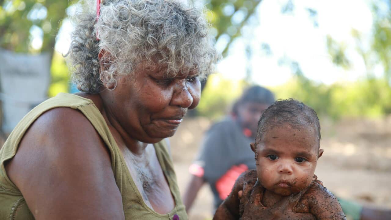 Our Medicine. Baby covered in clay for strengthening ceremony. NITV, SBS.jpg