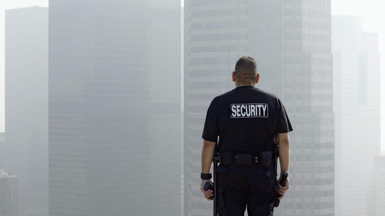 Security officer on roof of building