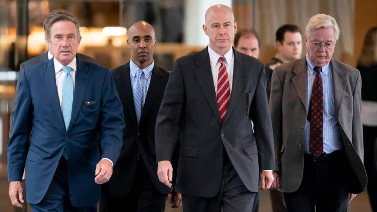 Former Minneapolis police officer Mohamed Noor walks with his lawyers into Court for the verdict in the shooting death of Justine