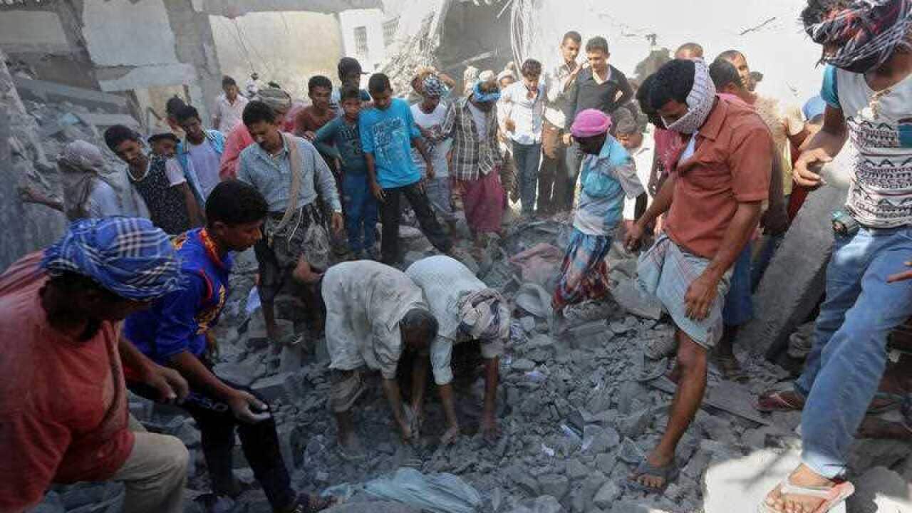 People search for survivors under rubble at the al-Zaydiya security headquarters, that was destroyed by Saudi-led airstrikes 