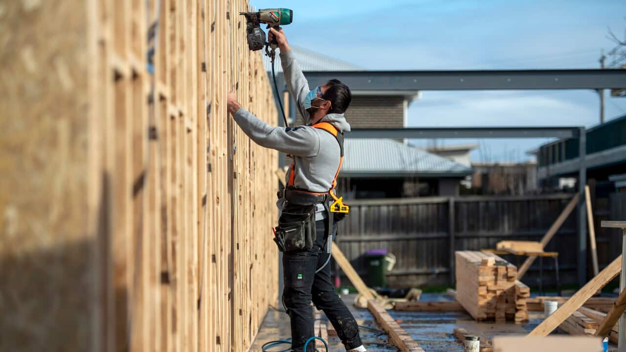 Construction worker on-site using a tool.