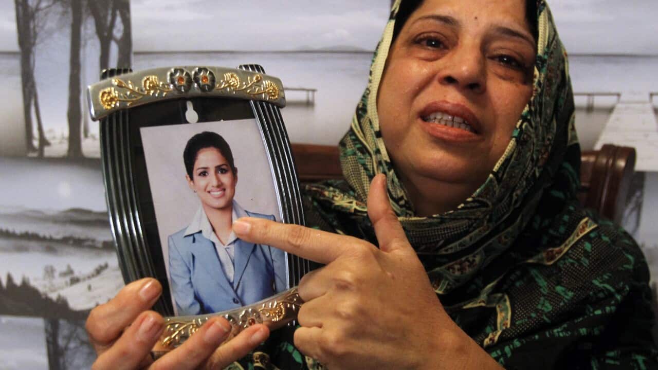 Pakistani mother, Sarwari Begum, shows a picture of her daughter, Bushra Khalique, 27, who is reportedly missing after a crush during the Hajj pilgrimage in Saudi Arabia
