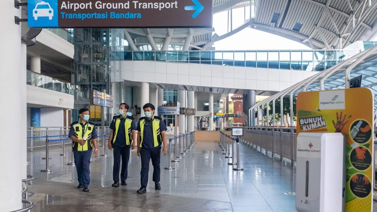 Workers at the international arrivals area during the opening of Ngurah Rai International airport in Bali
