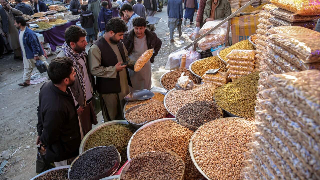 People shop in preparation for the Muslim festival of Eid al-Fitr in Kabul