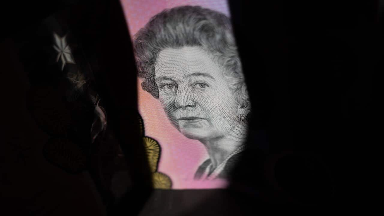 A $5 note showing the face of Queen Elizabeth II