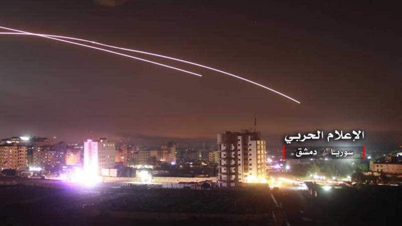 Syrian air defense missiles intercepting missile strikes over Damascus