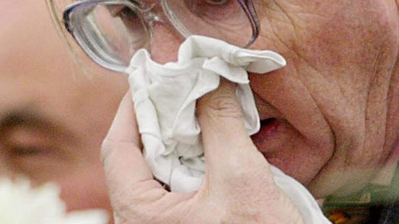 Elderly person blows nose