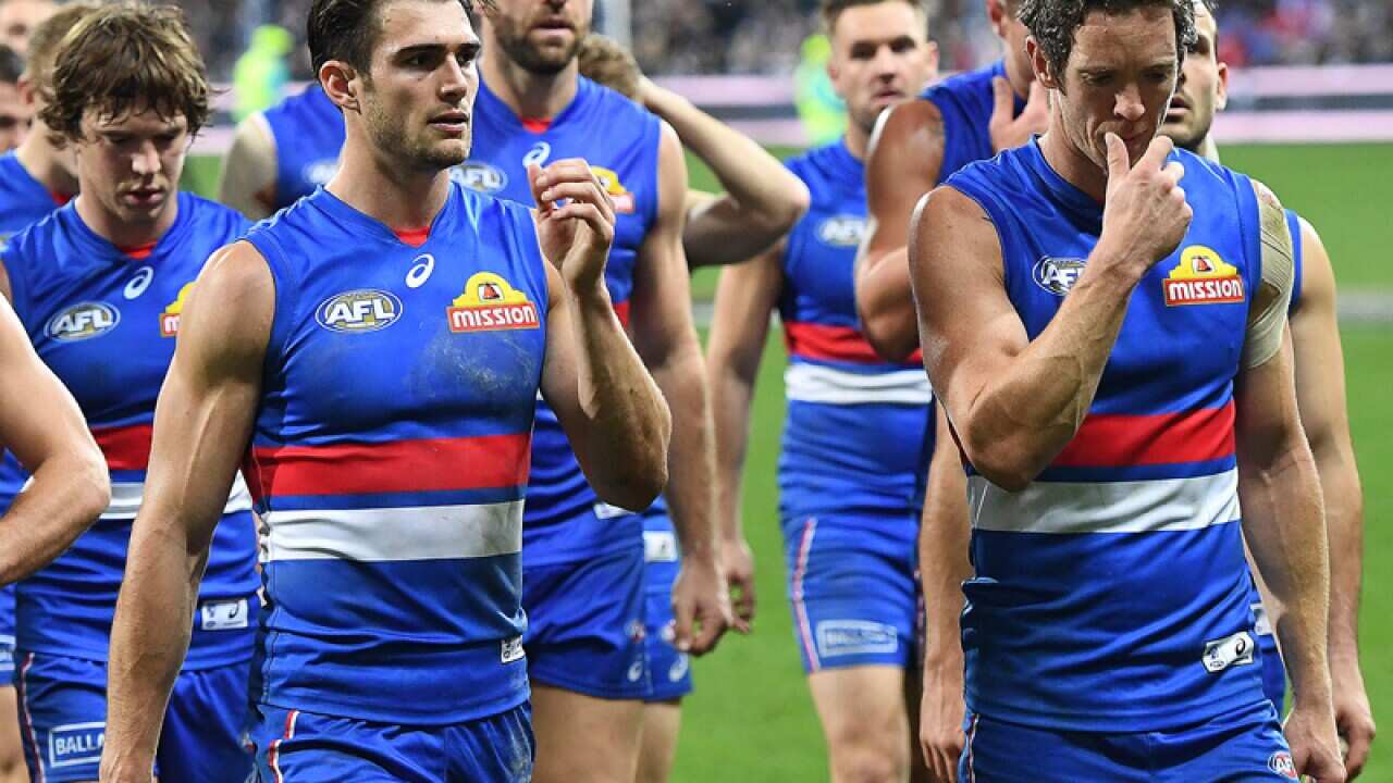 Robert Murphy of the Bulldogs leads his team