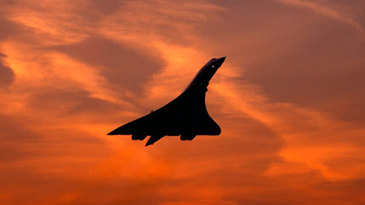 Silhouette of Concorde supersonic airplane against sunset sky