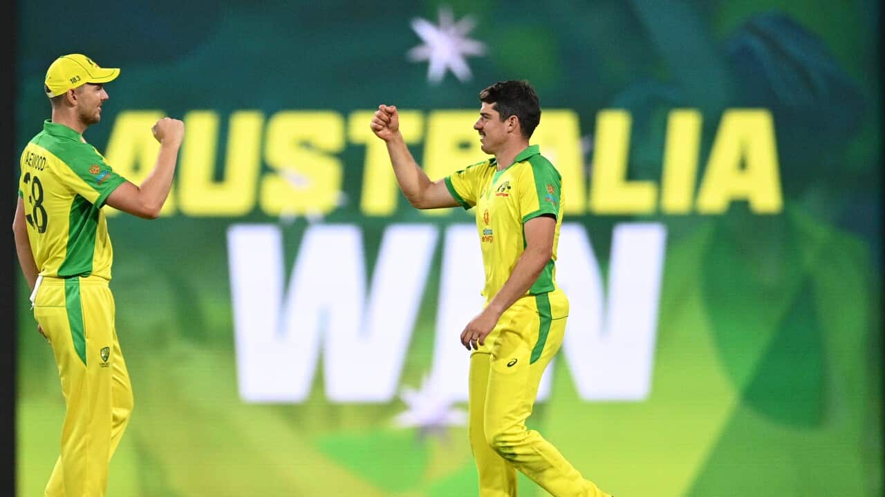 Josh Hazelwood (left) and Moises Henriques of Australia celebrate follwing their win in the second ODI cricket match between Australia and India at the SCG in Sydney, Sunday, November 29, 2020. (AAP Image/Dan Himbrechts)