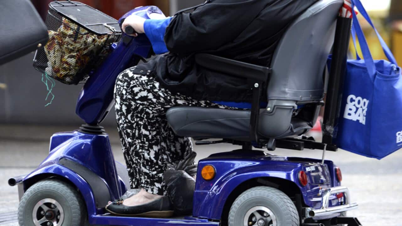 A person rides a motorised scooter
