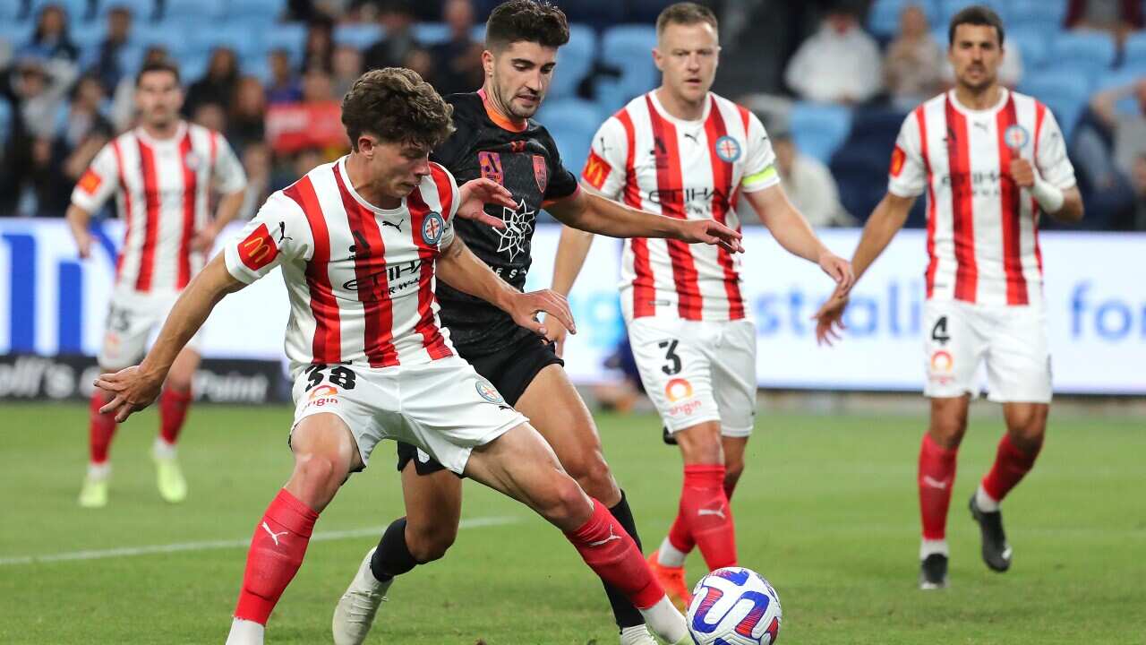 Jordan Bos of Melbourne City and Paulo Retre of Sydney FC challenge for the ball during the A-League Men's soccer match between Sydney FC and Melbourne City