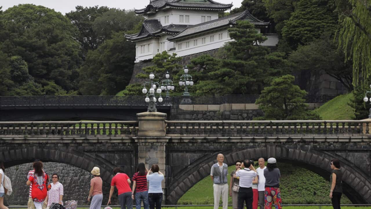 Tourists take photos of Doubled Bridge at Japan's Imperial Palace