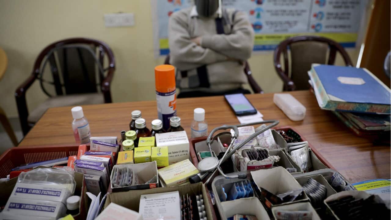 A doctor waits at an Indian vaccination room