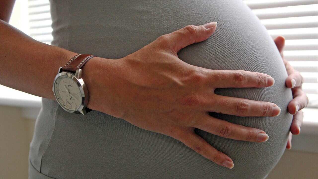 Pregnant woman holding belly
