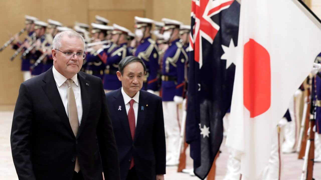 Australian Prime Minister Scott Morrison and Japan's Prime Minister Yoshihide Suga observe an honor guard in Tokyo, Japan, 17 November 2020.