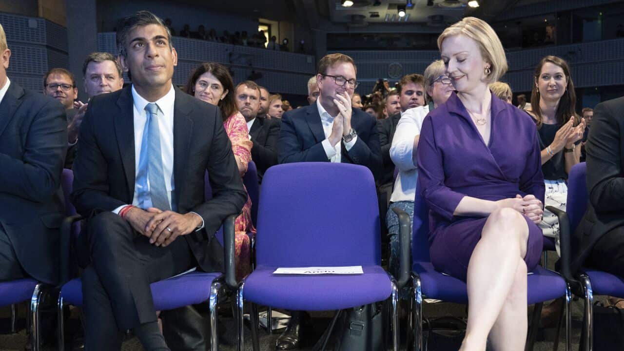 Woman sitting next to man