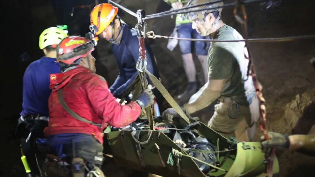 One of the 12 boys are carried out of the cave on stretchers.