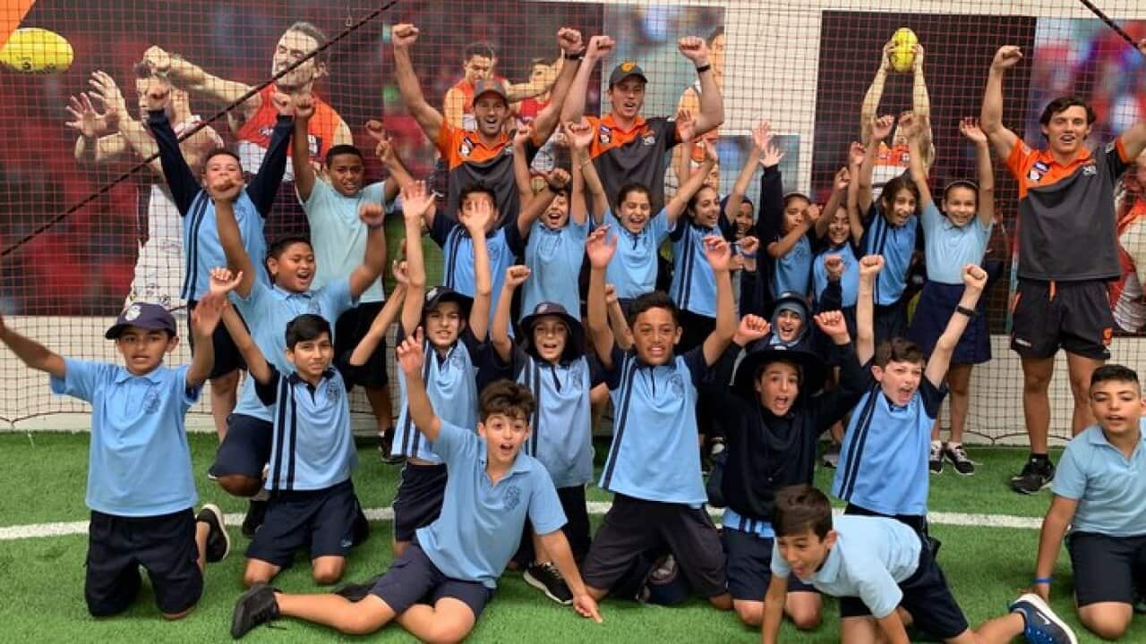 Giants players Callan Ward, Kieran Briggs and Jye Caldwell (L to R) with Greenacre School students