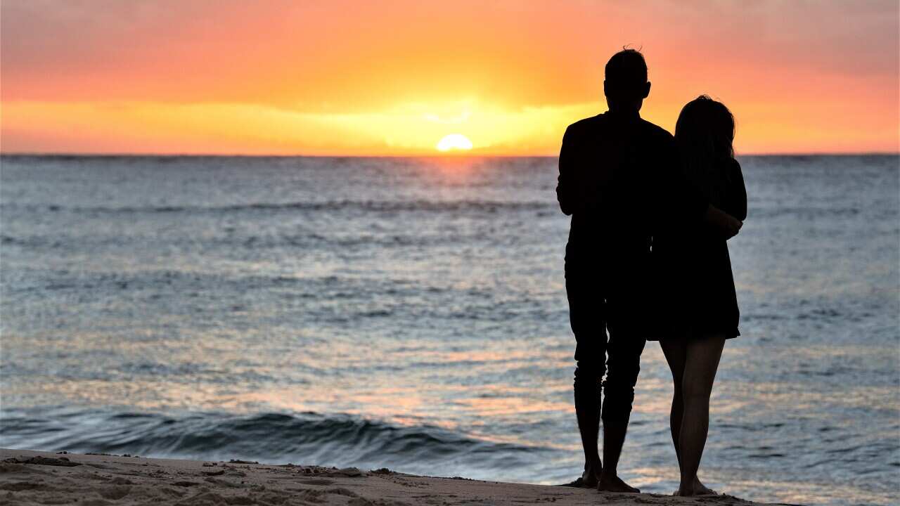 Revellers watch the sunrise on New Years Day at Bondi Beach in Sydney, Saturday, January 1, 2022.