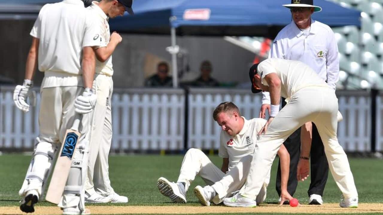 England bowler Jake Ball winces in pain.