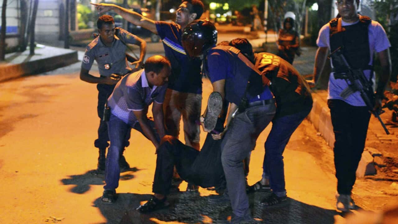 People help an unidentified injured, Bangladeshi capital Dhaka