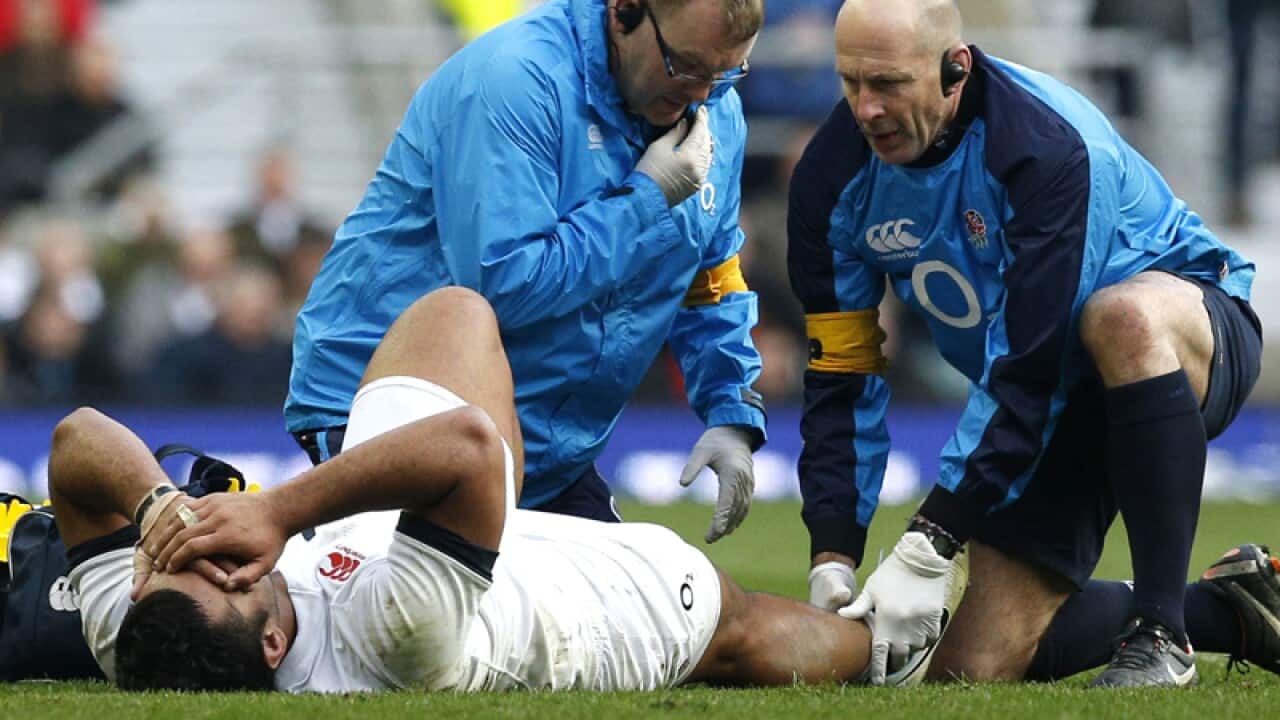 England's Billy Vunipola receives treatment from medical staff