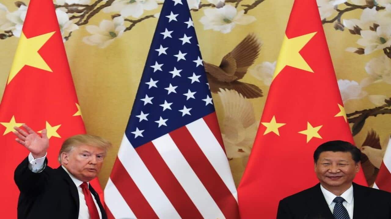 President Donald Trump waves next to Chinese President Xi Jinping
