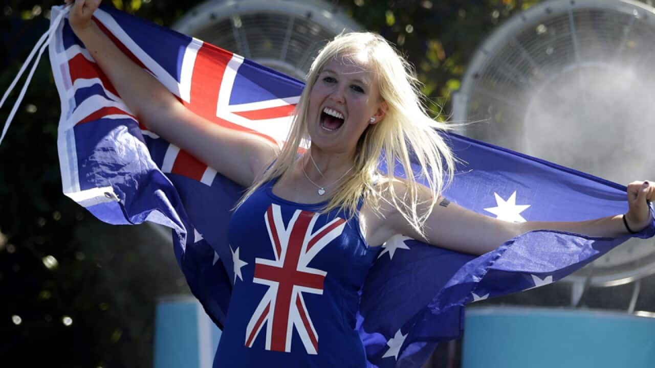 A spectator cools down in front of a fan