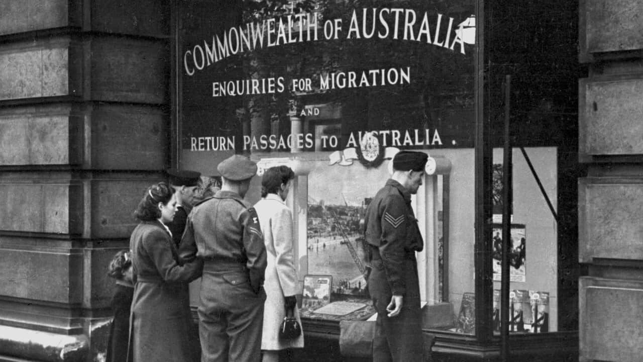 Prospective migrants look at a window display about Australia in London in 1945