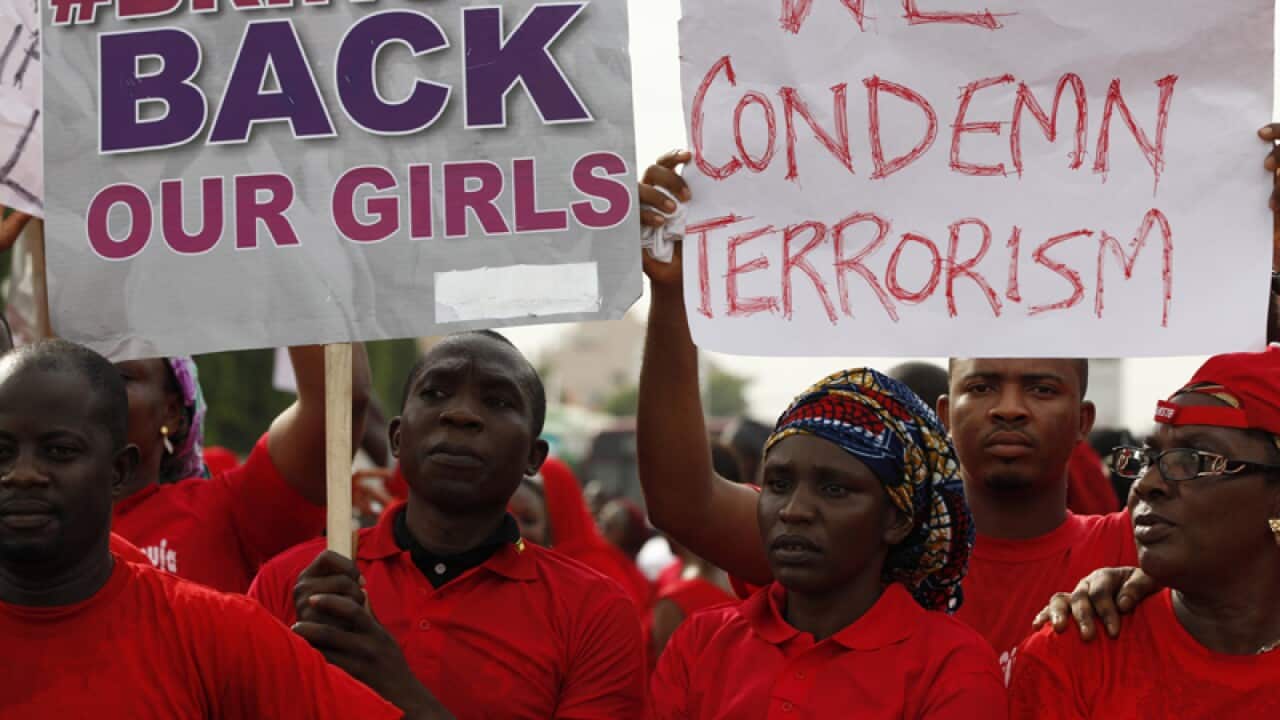 People attend a demonstration to call for the return of schoolgirls