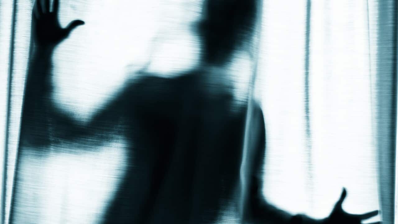 Figure behind a curtain