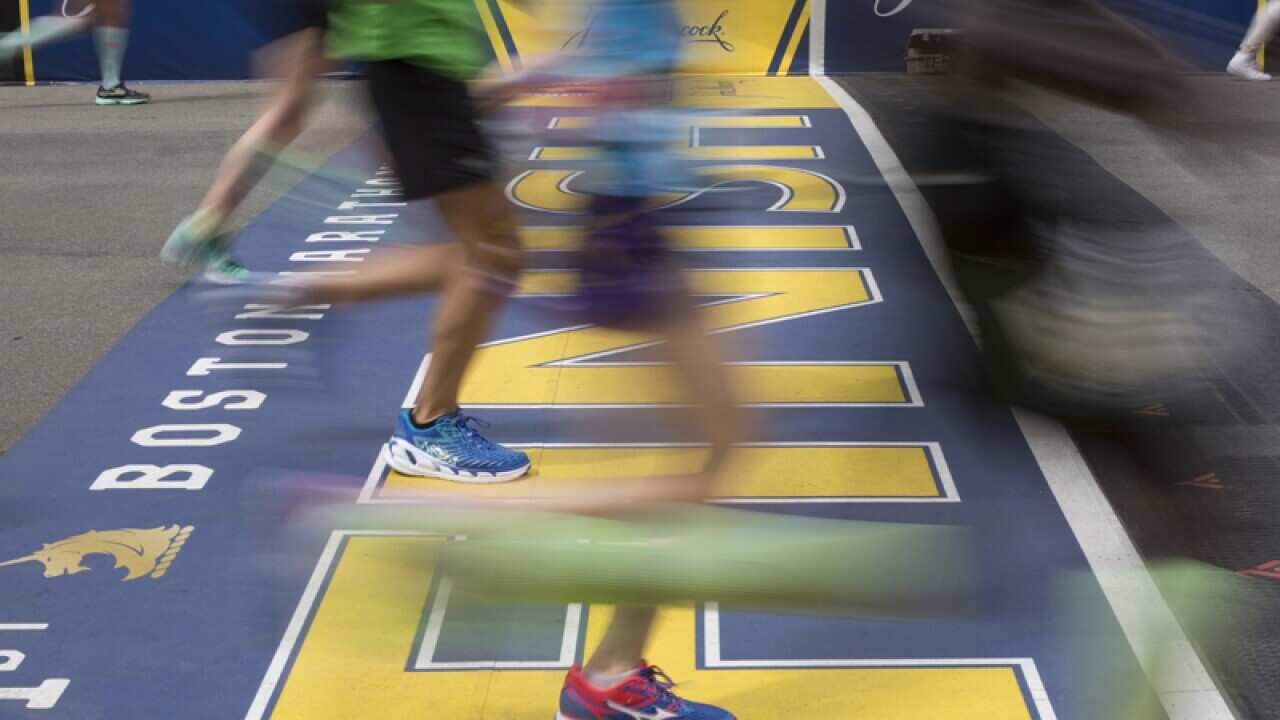 Runners crossing the finish line of the 121st Boston Marathon