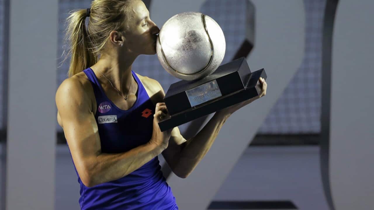 Lesia Tsurenko of Ukraine kisses the trophy after winning