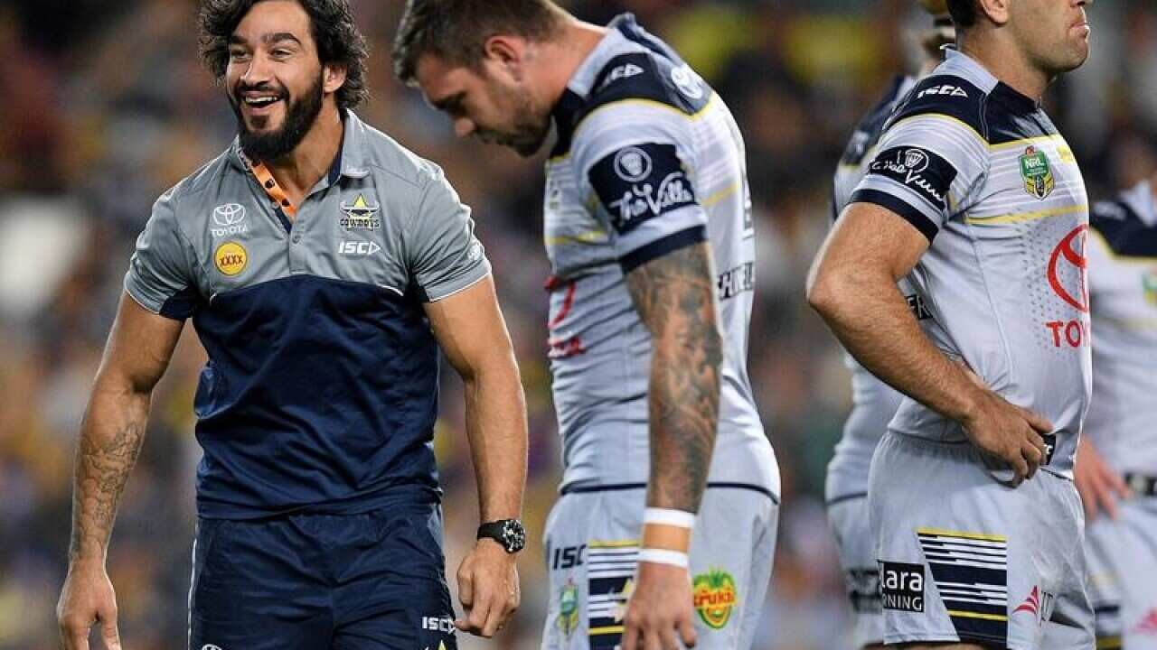 Johnathan Thurston is seen on the field as the Cowboys warm up.