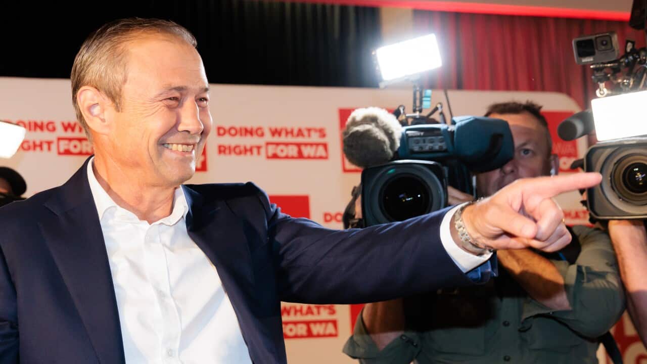 A man smiling and pointing