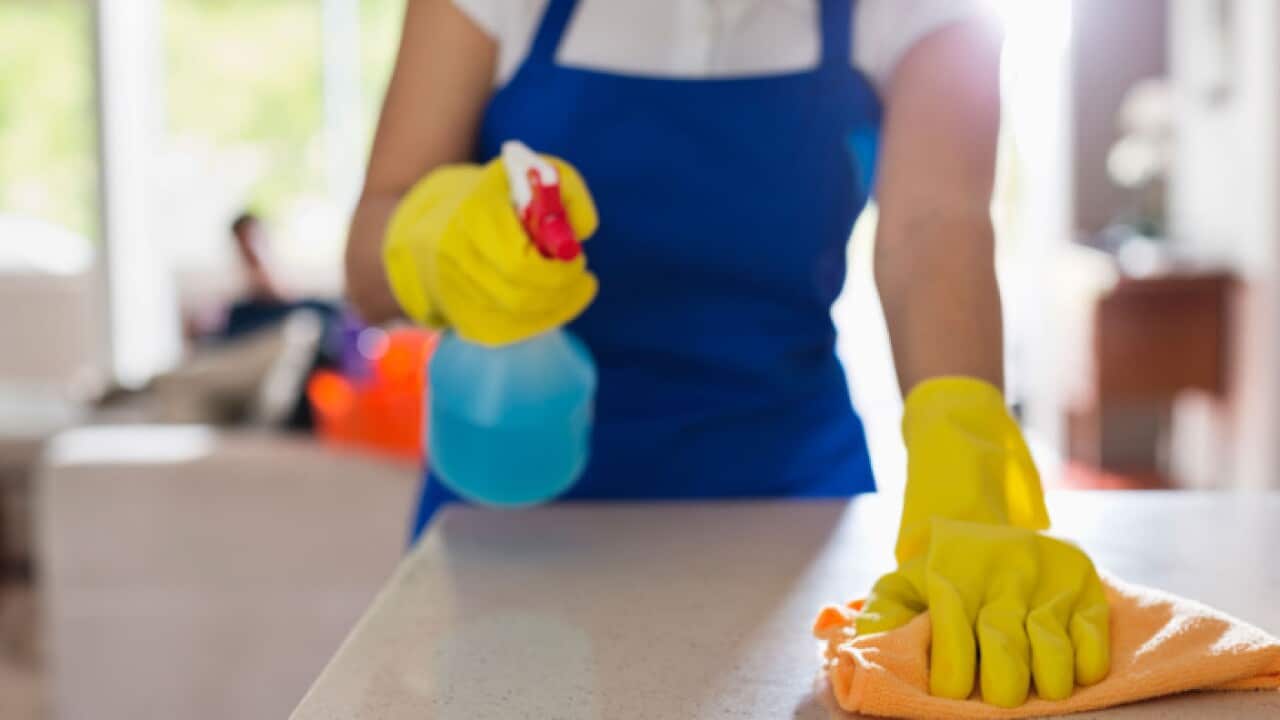 Woman cleaning kitchen counter