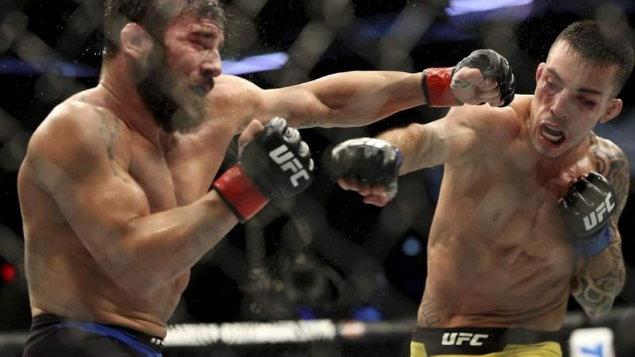 Jimmie Rivera, left, trades punches with Thomas Almeida