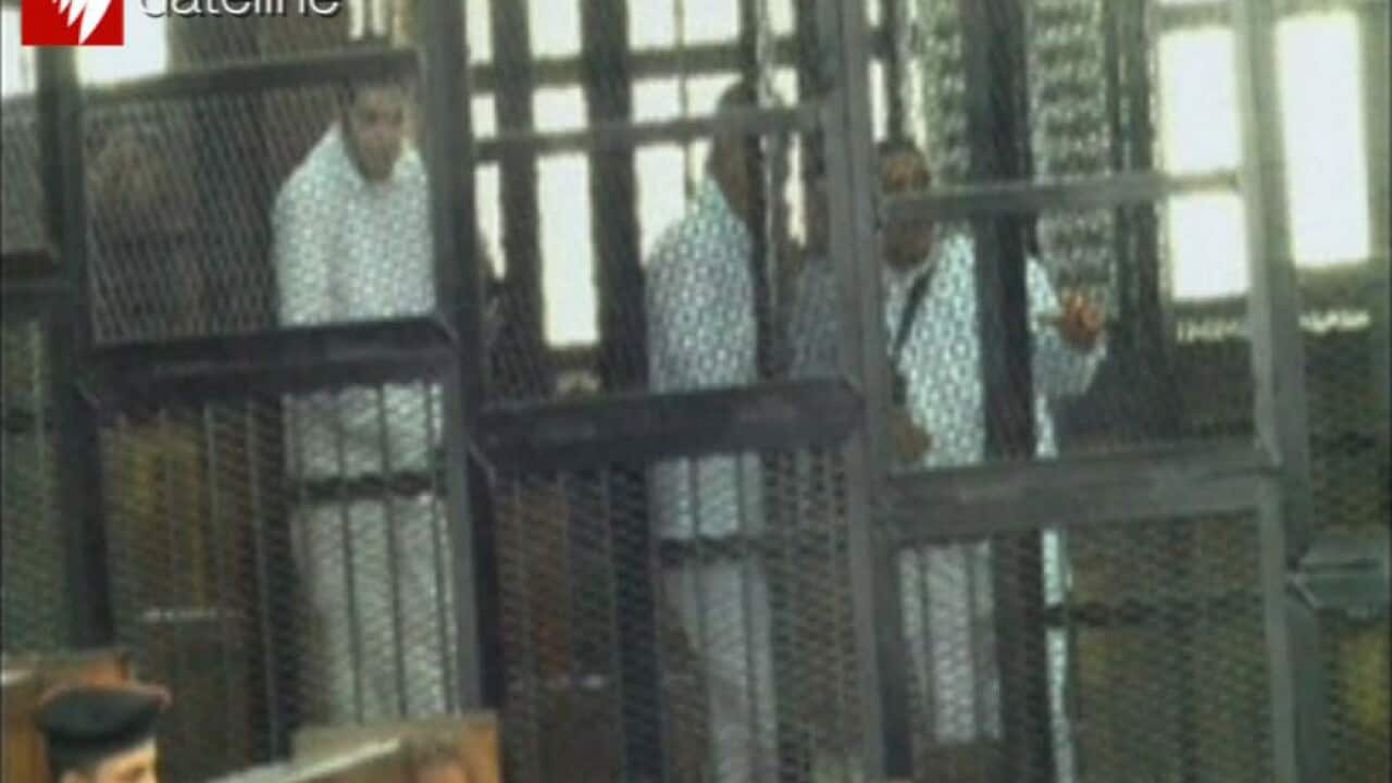 Peter Greste (centre) is seen with some of his co-accused.