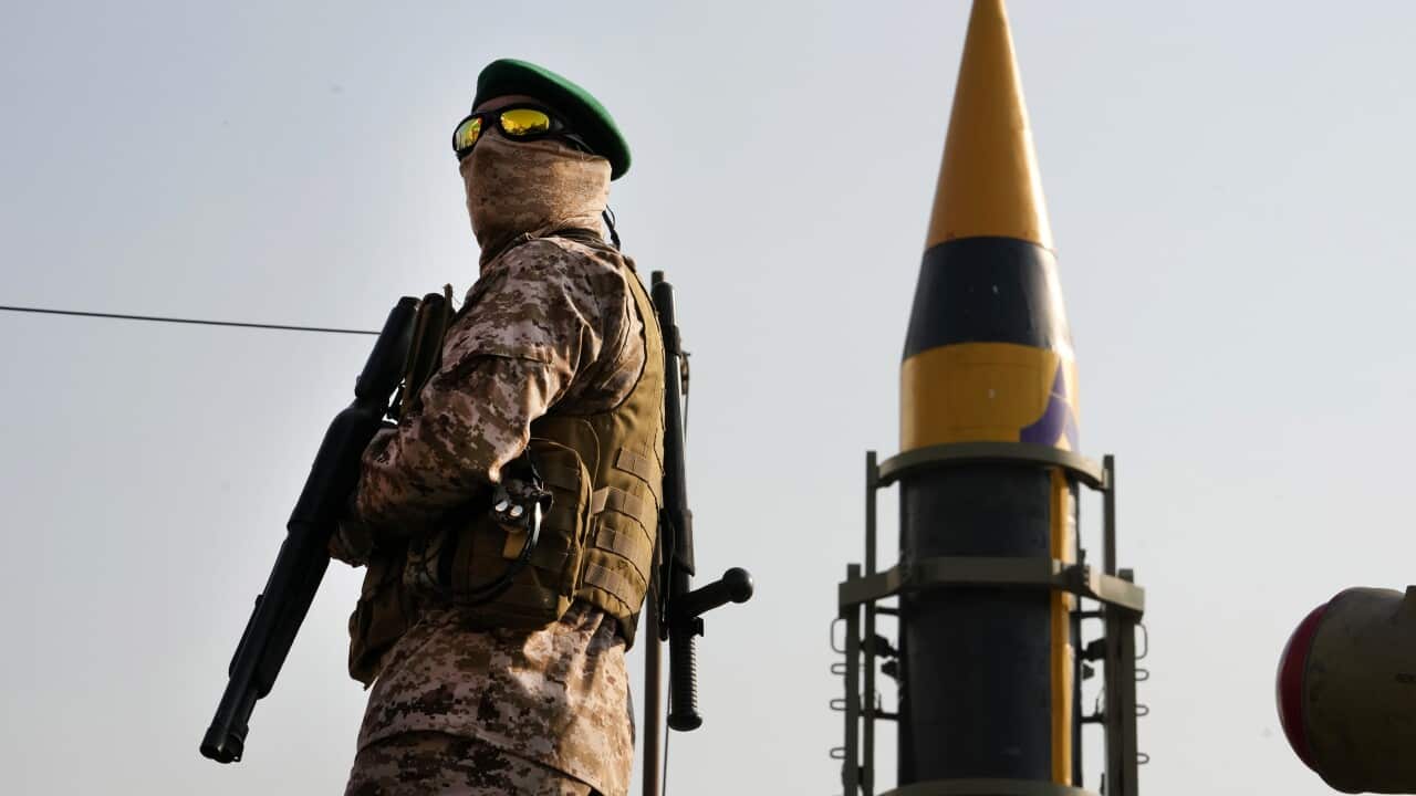 A military guard in front of a monument