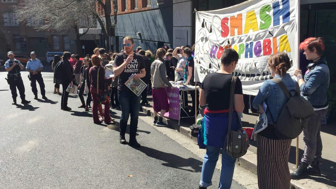 A crowd gathered outside the offices of a newspaper to protest the banning of documentary Gayby Baby from screening in schools, Sunday, Aug. 30, 2015. (AAP Image/Caris Bizzaca) NO ARCHIVING
