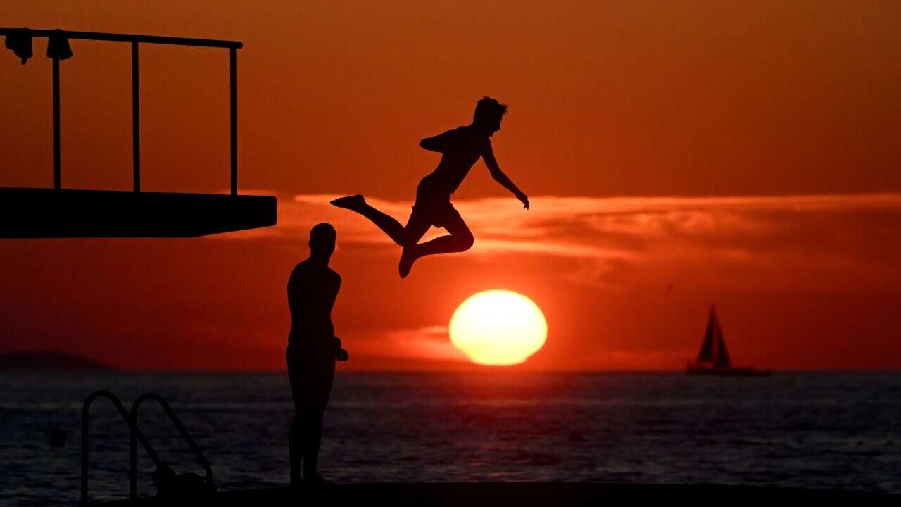 People jump into the Adriatic Sea in Zadar, Croatia