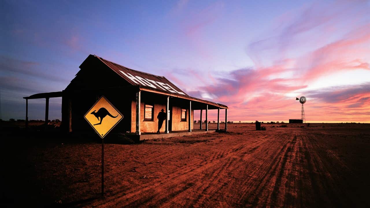 Australia, New South Wales, man standing on hotel porch, silhouette