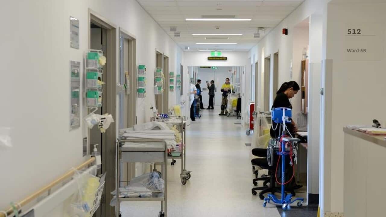 Hospital corridor with staff and equipment